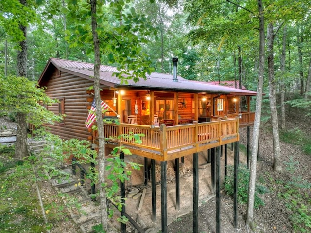 rear view of property with a wooden deck