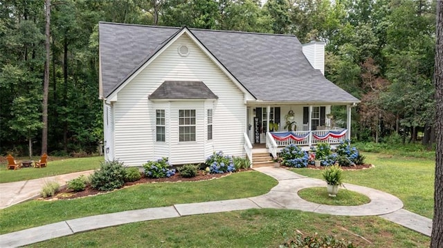 10 Stagg Trce, Social Circle, GA 30025 - view of front of house with a porch, a front yard, roof with shingles, and a chimney