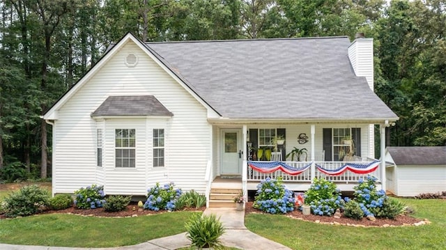 10 Stagg Trce, Social Circle, GA 30025 - view of front of home with covered porch, a chimney, roof with shingles, an outbuilding, and view of scattered trees