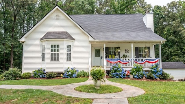 10 Stagg Trce, Social Circle, GA 30025 - view of front of house featuring covered porch, a chimney, a front yard, and roof with shingles