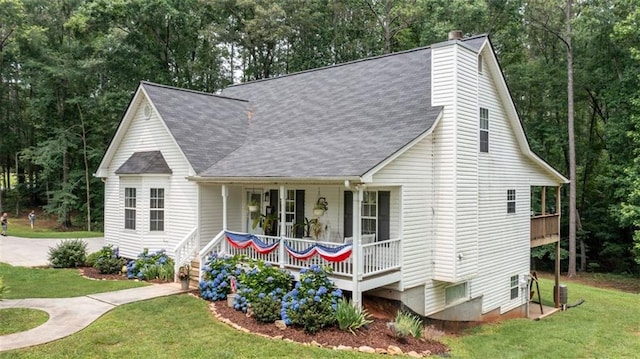 10 Stagg Trce, Social Circle, GA 30025 - view of front of property with covered porch, a front yard, a shingled roof, a chimney, and view of scattered trees