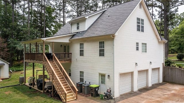 10 Stagg Trce, Social Circle, GA 30025 - back of property with stairway, a shingled roof, asphalt driveway, central AC, and an attached garage