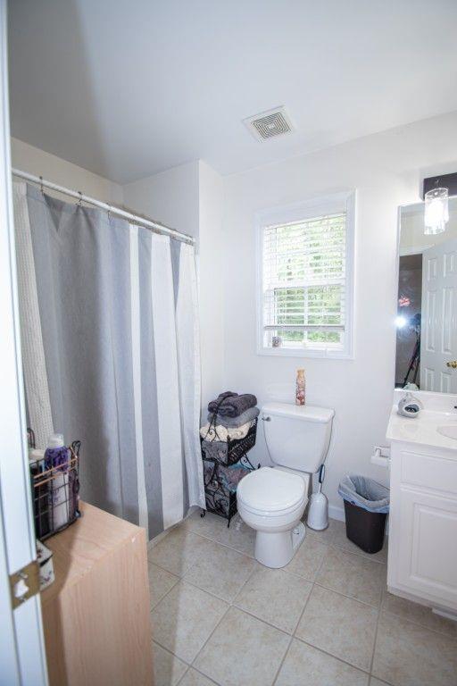 10 Stagg Trce, Social Circle, GA 30025 - bathroom featuring vanity, tile patterned flooring, toilet, and baseboards