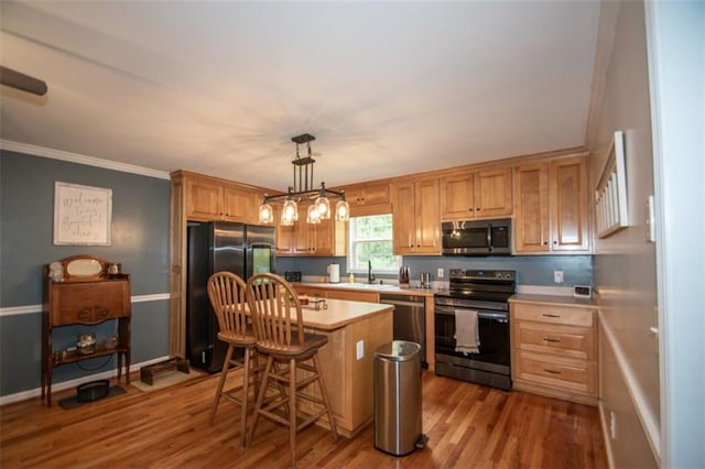 10 Stagg Trce, Social Circle, GA 30025 - kitchen featuring stainless steel appliances, light countertops, a sink, crown molding, and wood finished floors