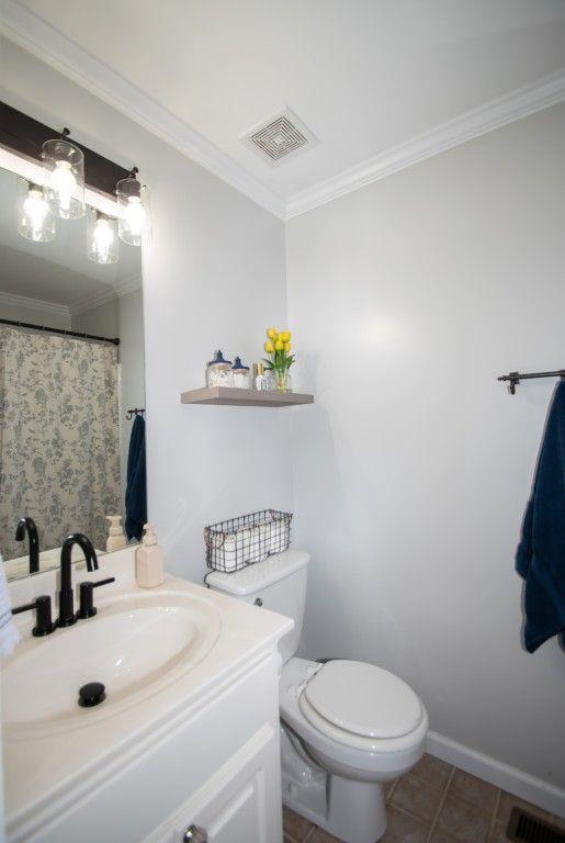 10 Stagg Trce, Social Circle, GA 30025 - bathroom featuring crown molding, vanity, toilet, and tile patterned flooring