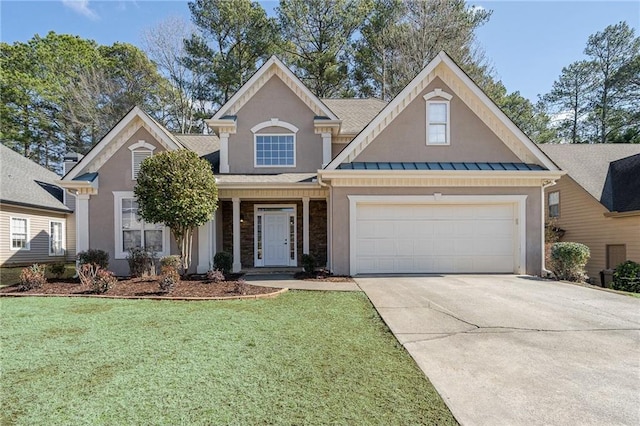 view of front facade featuring metal roof, an attached garage, concrete driveway, a standing seam roof, and a front yard