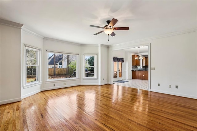 321 Covered Bridge Pl SW, Smyrna, GA 30082 - unfurnished living room featuring a chandelier, a ceiling fan, crown molding, wood finished floors, and baseboards