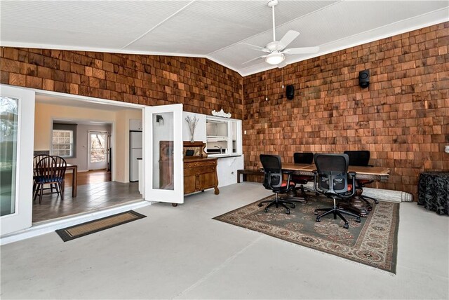 office space featuring ceiling fan, concrete floors, and lofted ceiling