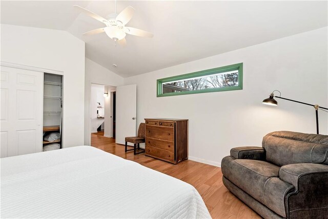 bedroom with a closet, ceiling fan, vaulted ceiling, and light wood-type flooring