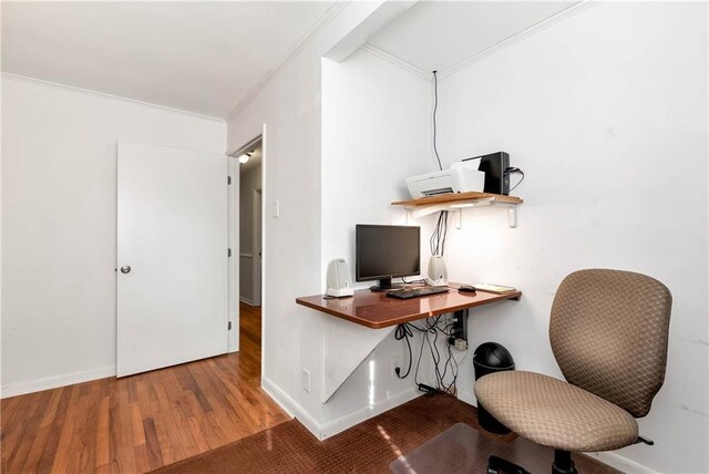 home office featuring hardwood / wood-style flooring and ornamental molding