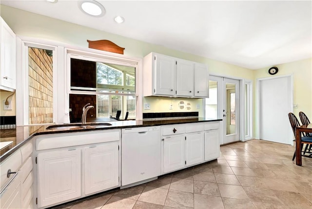 kitchen featuring sink, white cabinetry, white dishwasher, and light tile patterned flooring