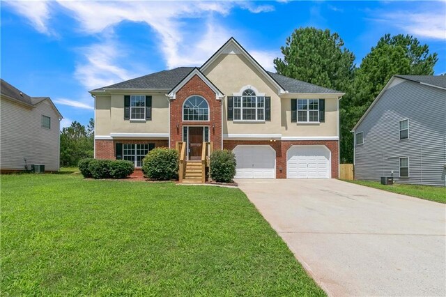 split foyer home with a front lawn and a garage