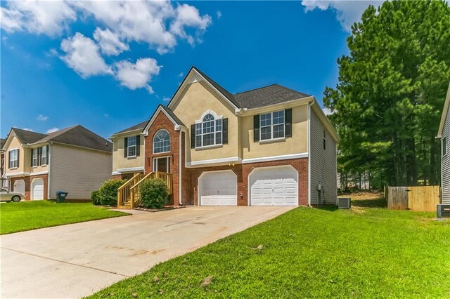 raised ranch with a garage and a front lawn