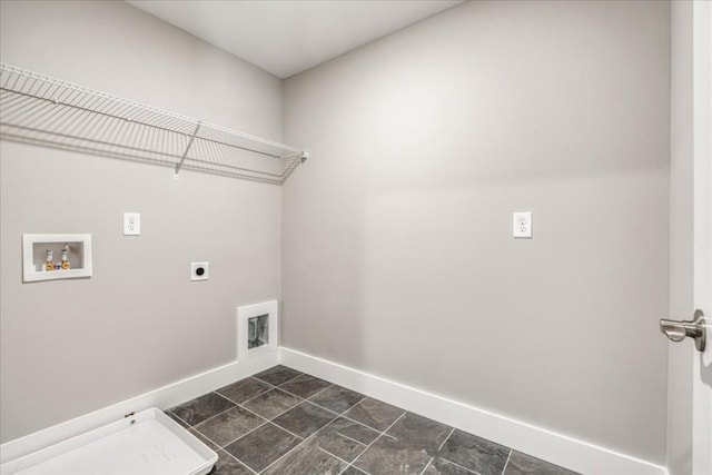 laundry room with washer hookup, electric dryer hookup, and dark tile patterned flooring