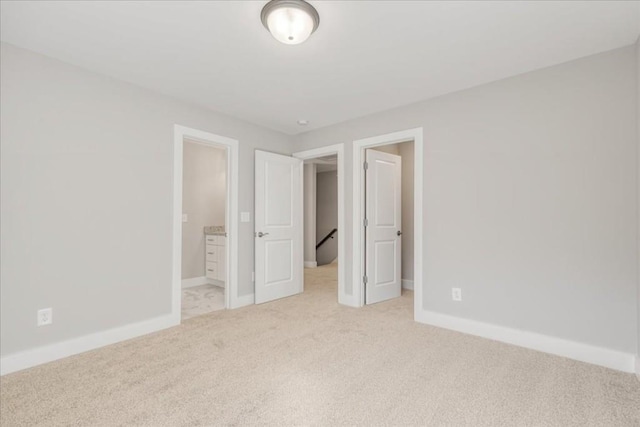 unfurnished bedroom featuring light colored carpet