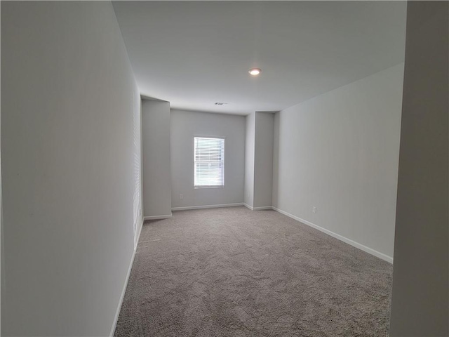 unfurnished room with light carpet