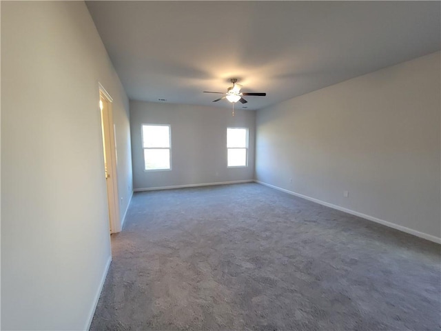 carpeted spare room featuring ceiling fan