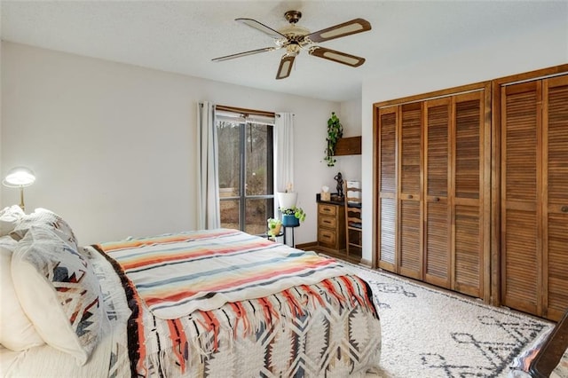 bedroom with two closets and ceiling fan