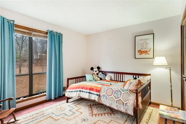 carpeted bedroom with a textured ceiling