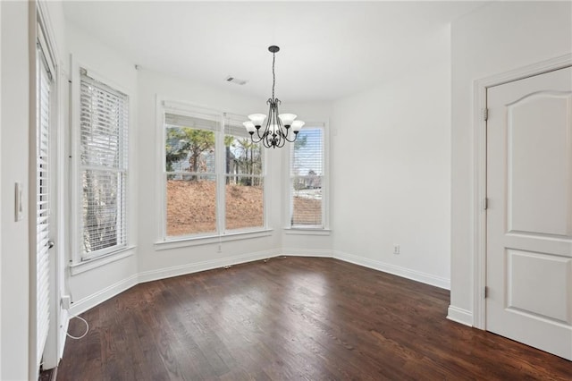 unfurnished dining area with baseboards, dark wood-style flooring, and an inviting chandelier