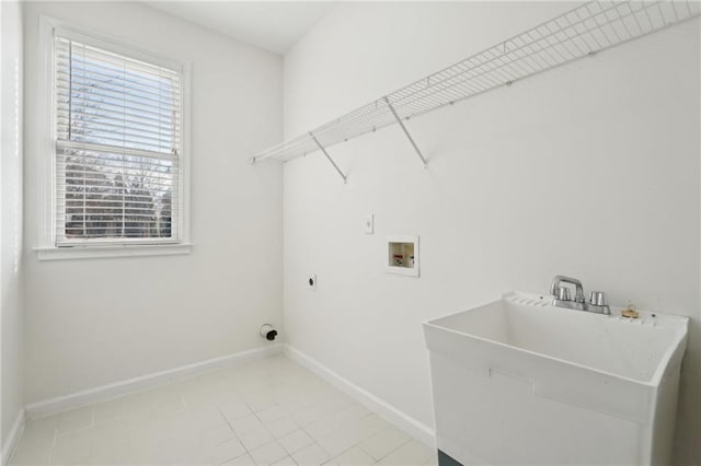 clothes washing area with laundry area, baseboards, electric dryer hookup, washer hookup, and a sink