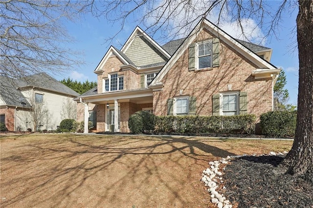 craftsman house featuring a porch and brick siding