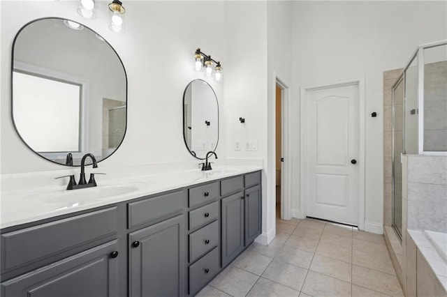 full bathroom featuring double vanity, a sink, a shower stall, and tile patterned floors