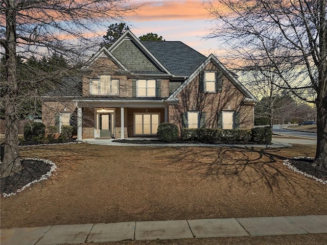 craftsman house featuring brick siding