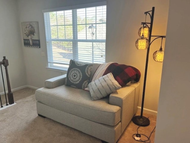 living area featuring carpet flooring and baseboards