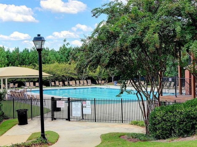 pool featuring a patio and fence