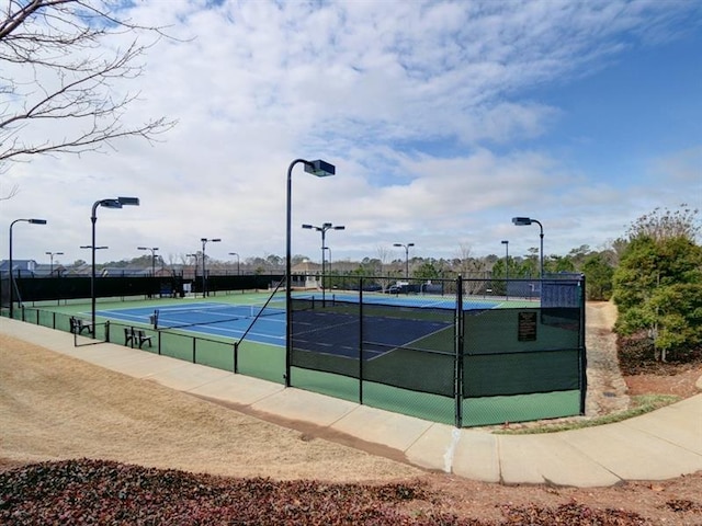 view of sport court featuring fence