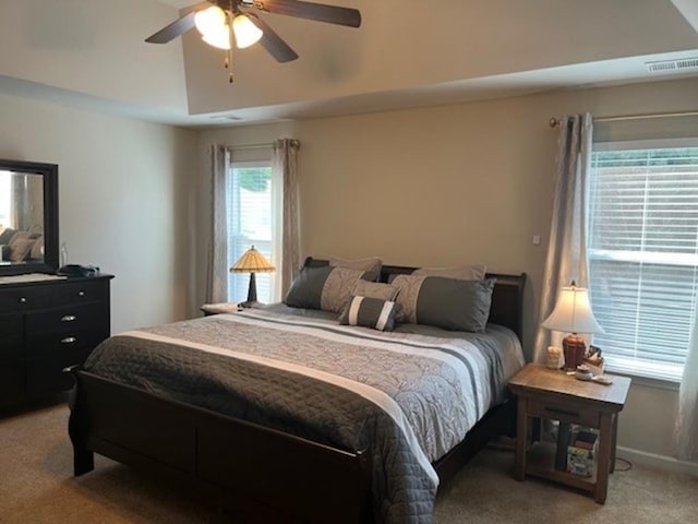 bedroom with light carpet, baseboards, visible vents, and ceiling fan