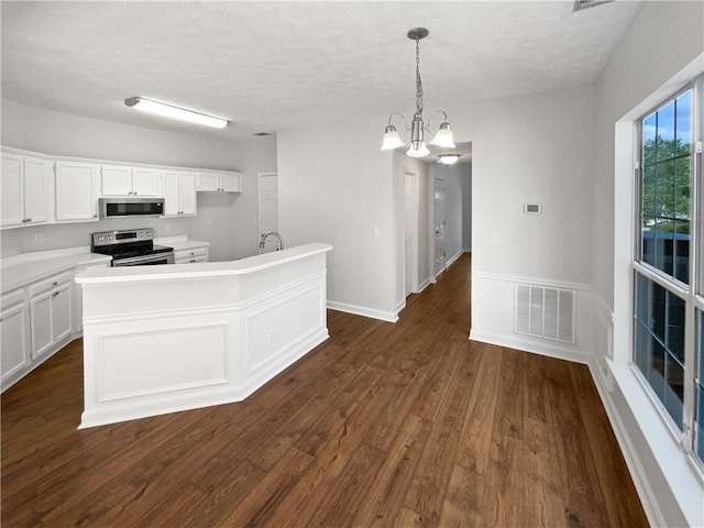 3968 Oak Glenn Dr, Duluth, GA 30096 - kitchen with appliances with stainless steel finishes, dark wood-type flooring, an island with sink, white cabinets, and a chandelier