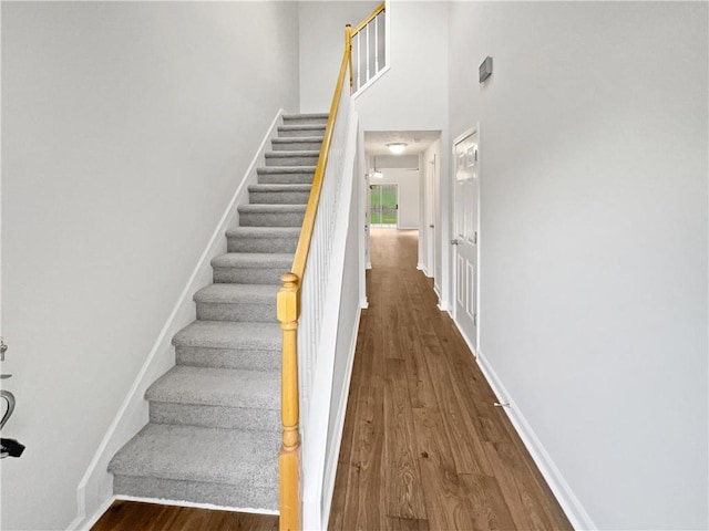 3968 Oak Glenn Dr, Duluth, GA 30096 - stairs featuring wood finished floors, a high ceiling, and baseboards
