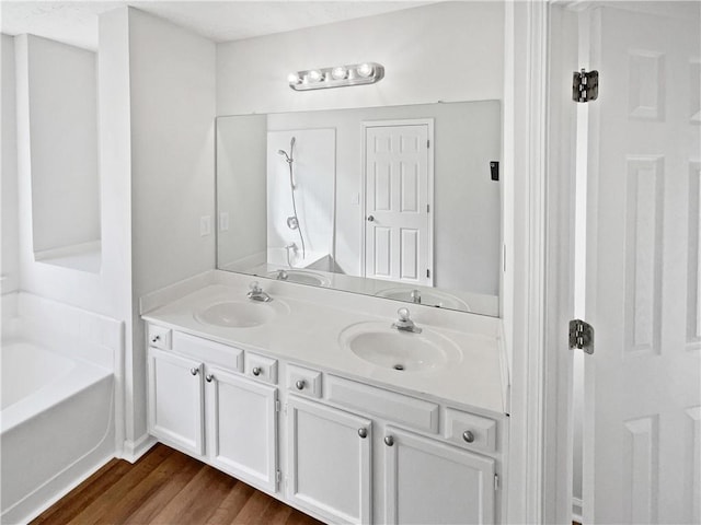 3968 Oak Glenn Dr, Duluth, GA 30096 - bathroom featuring wood finished floors, double vanity, and a bath