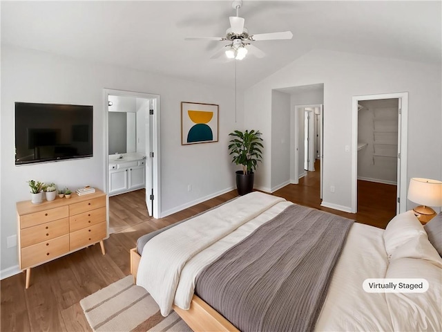 3968 Oak Glenn Dr, Duluth, GA 30096 - bedroom featuring wood finished floors, lofted ceiling, baseboards, and a walk in closet