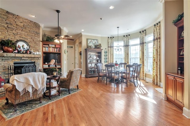 interior space with crown molding, baseboards, a fireplace, and light wood finished floors