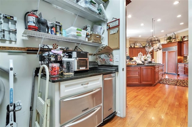 kitchen featuring paneled refrigerator, light wood-style flooring, recessed lighting, ornamental molding, and brown cabinets