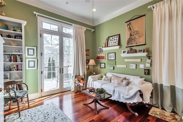 living area with french doors, ornamental molding, and wood finished floors