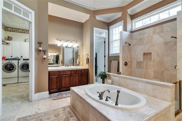 bathroom featuring a garden tub, ornamental molding, washing machine and dryer, vanity, and tiled shower