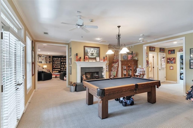 playroom featuring ceiling fan, light carpet, a fireplace, baseboards, and ornamental molding