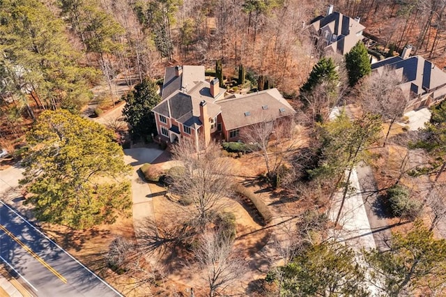 birds eye view of property featuring a view of trees