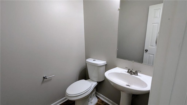 3881 Micah Ln, Ellenwood, GA 30294 - bathroom with toilet, baseboards, and a sink