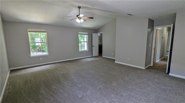 3881 Micah Ln, Ellenwood, GA 30294 - carpeted empty room with a ceiling fan, baseboards, vaulted ceiling, and a textured ceiling