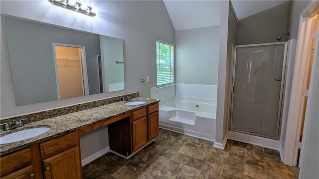 3881 Micah Ln, Ellenwood, GA 30294 - full bath featuring a shower stall, a garden tub, double vanity, vaulted ceiling, and a walk in closet