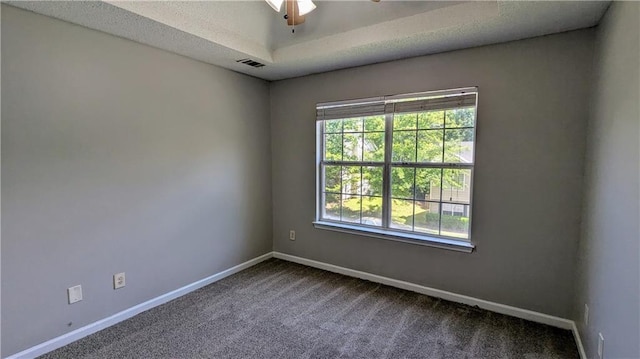 3881 Micah Ln, Ellenwood, GA 30294 - spare room with baseboards, dark carpet, ceiling fan, and a raised ceiling