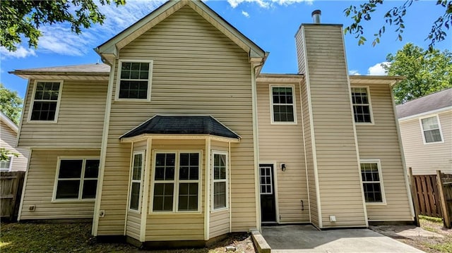 3881 Micah Ln, Ellenwood, GA 30294 - back of property with a patio area and a chimney
