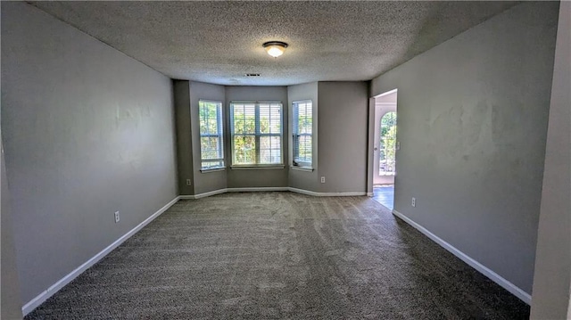3881 Micah Ln, Ellenwood, GA 30294 - carpeted empty room with a textured ceiling and baseboards