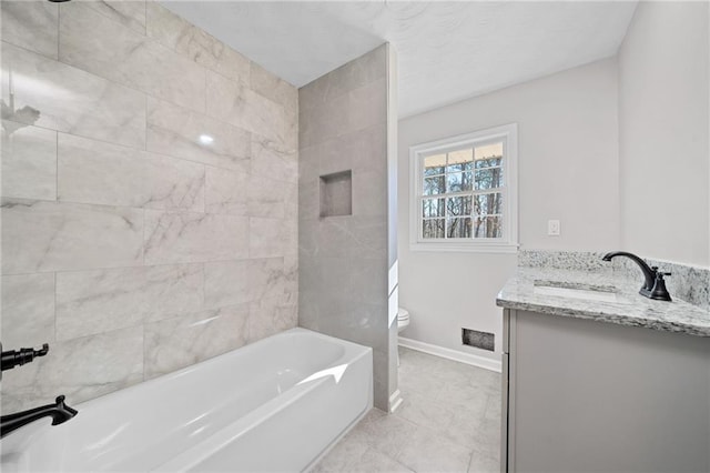 bathroom with tile patterned flooring, toilet, vanity, and baseboards