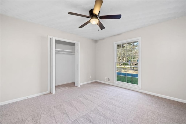 unfurnished bedroom with a closet, visible vents, baseboards, and carpet floors